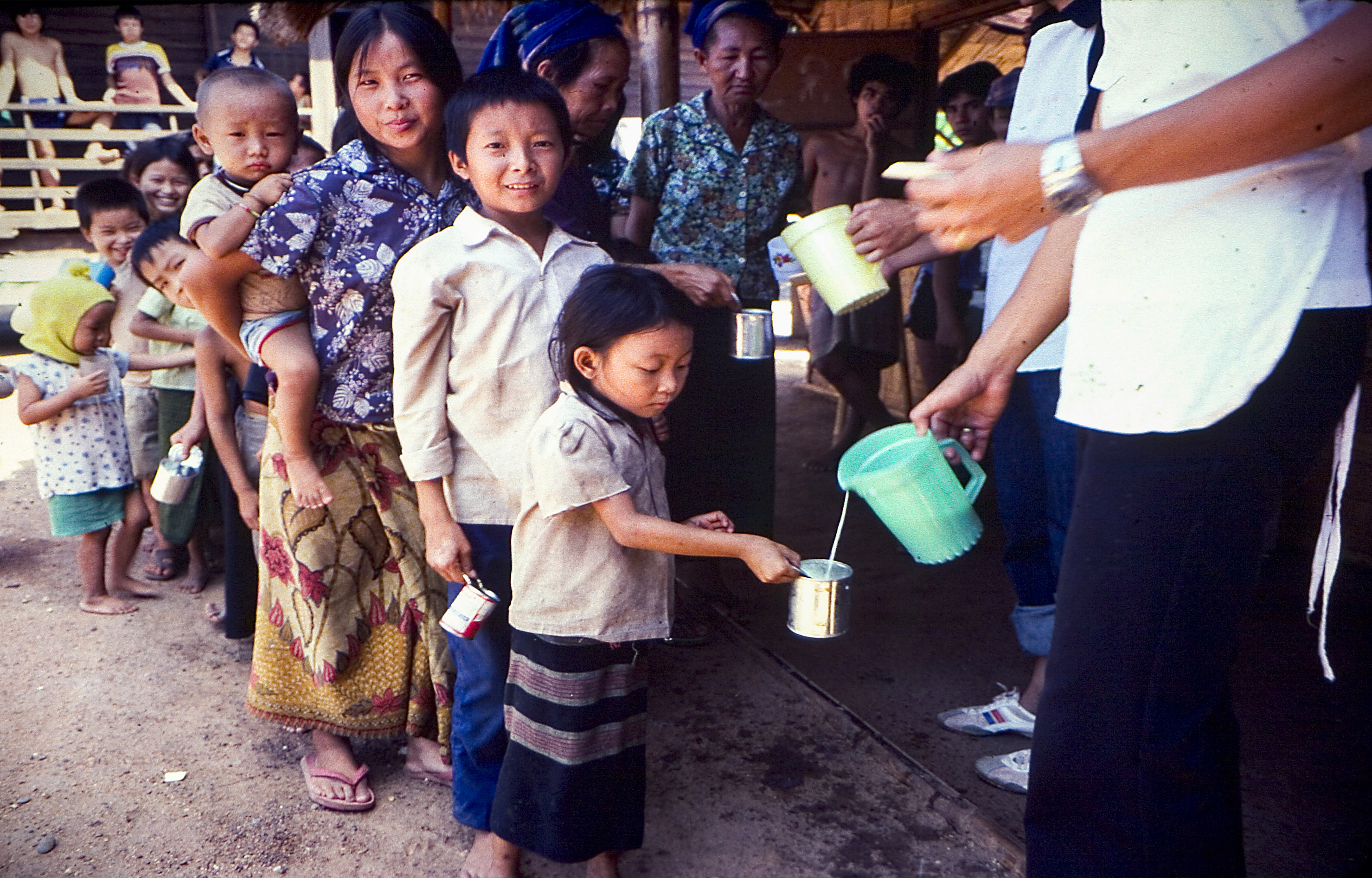 Refugees receiving food at Thai refugee camp.